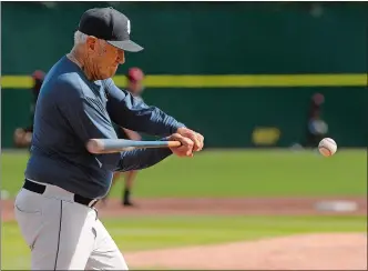  ?? DANA JENSEN/THE DAY ?? Andy Baylock, 80, hits balls during drills for the Connecticu­t Tigers’ infielders before their game on Thursday at Dodd Stadium in Norwich.