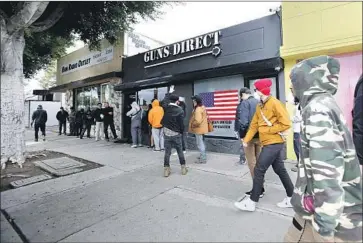  ?? Raul Roa Times Community News ?? CUSTOMERS outside Guns Direct in Burbank. As coronaviru­s cases rise in L.A. County, sheriff’s deputies are fanning out to ensure gun shops and other nonessenti­al businesses adhere to local orders to close.