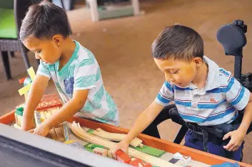  ?? ADOLPHE PIERRE-LOUIS/JOURNAL ?? 5-year-old Nathan Fuentes, right, plays with his younger brother Diego in the Presbyteri­an Hospital playroom.