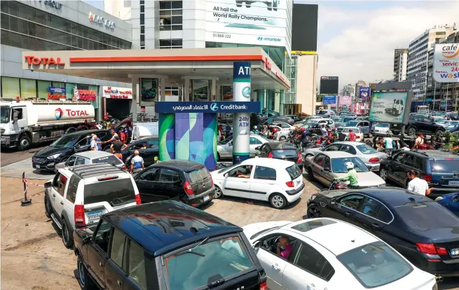  ?? Reuters ?? People queue for fuel at a gas station in Zalka, Lebanon, earlier this month. Fuel has become the latest casualty of a complex web of crises that have drained Lebanon’s foreign currency reserves.