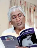  ??  ?? Prof. Ariyaratne leafs through his book. Ananda Samarakoon- A Critical Study.
Pic by Indika Handuwala