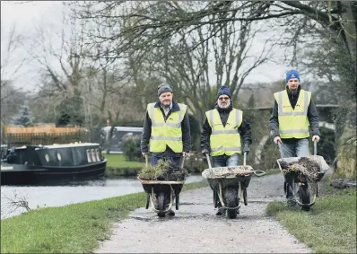  ??  ?? From left, volunteers Eddie Wilson, Simon Thornes and Ian Stow at work on the canal in Saltaire