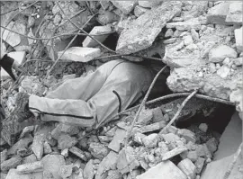  ?? Pedro Pardo AFP/Getty Images ?? A RESCUER searches for survivors in Juchitan de Zaragoza, Oaxaca state, where at least 36 people died in the 8.1 quake. Three days of mourning were declared.