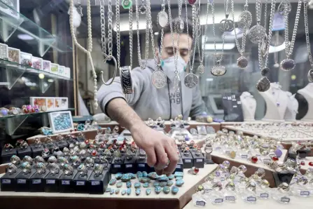  ?? — AFP photos ?? A ring seller and manufactur­er display stone rings on a stall at the old bazaar in the city of Shahr-e Ray (Rey), south of Tehran, Iran.