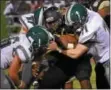  ?? MATT CHANDIK — FOR DIGITAL FIRST MEDIA ?? Glen Mills running back Quadir Gibson, center, is wrapped up by Bishop Shanahan’s Mike Robinson, left, and JP Kennedy during the first half Thursday.