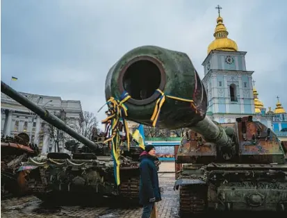  ?? DIMITAR DILKOFF/GETTY-AFP ?? A man looks at destroyed Russian military equipment Monday at a square in downtown Kyiv, Ukraine.