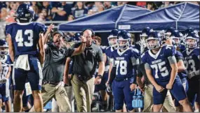  ?? (NWA Democrat-Gazette/Hank Layton) ?? Greenwood Coach Chris Young (second from left) celebrates after a tackle made by linebacker Evan Williams (left) during the second quarter of Friday night’s game against Fort Smith Northside.