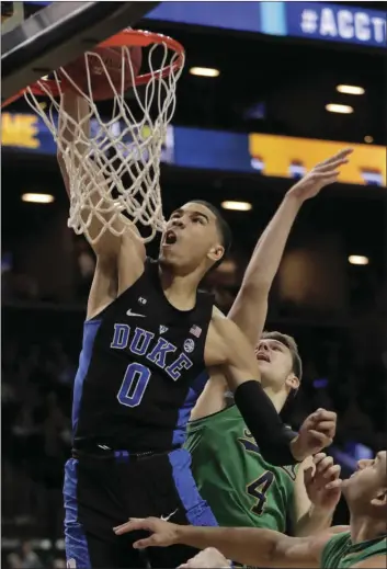  ??  ?? Duke Blue Devils forward Jayson Tatum (left) dunks the ball against Notre Dame Fighting Irish in the first half of an NCAA college basketball game during the championsh­ip game of the Atlantic Coast Conference tournament Saturday in New York. AP PHOTO