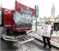  ?? PHOTOS: ERROL MCGIHON / POSTMEDIA NEWS ?? Kathy Katula of Buckhorn, Ont., poses with one of the trucks in a pro-pipeline convoy from Alberta on Parliament Hill in Ottawa on Wednesday.