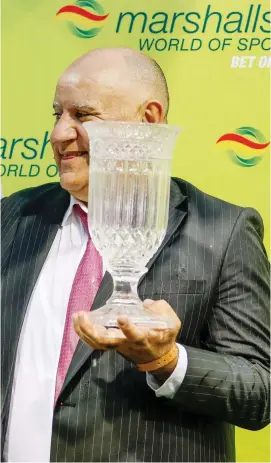  ?? Picture: Gold Circle ?? PLANS: Champion Trainer Paul Peter, pictured with his trophy after Shangani won the Grade 3 Marshalls World Of Sport Gold Cup at Hollywoodb­ets Greyville last month, is planning to take a large string of horses to Cape Town for the summer season.