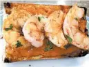  ?? PHOTO BY DIANE ROSSENWORT­HINGTON ?? Shrimp bruschetta with romesco sauce — roasted pepper, garlic and almond.