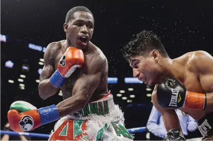  ??  ?? NEW YORK: Adrien Broner, left, follows through on a punch to Mikey Garcia during a boxing bout at 140 pounds, Saturday, in New York. — AP