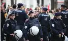  ?? Photograph: Anadolu Agency/ ?? Police officers stand guard as people gather in Vienna to protest against Covid restrictio­ns.