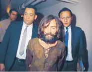  ?? ASSOCIATED PRESS ?? Charles Manson is escorted to his arraignmen­t on conspiracy-murder charges in connection with the Sharon Tate murder case in 1969. Manson died of natural causes Sunday after nearly a half-century in prison.