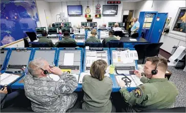  ?? Al Seib Los Angeles Times ?? MEMBERS of an interconti­nental ballistic missile launch team prepare for a May 3 test at Vandenberg Air Force Base. In another test Wednesday, a missile traveled 4,200 miles to a test range in the Marshall Islands.