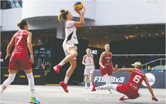  ?? DAVID BLOOM ?? Team Canada’s Michelle Plouffe sends Team Poland’s Martyna Cebulska flying as she sets up for a shot during the FIBA 3-on-3 Women’s Basketball Series Saturday in Edmonton. Canada was a force on the tour.