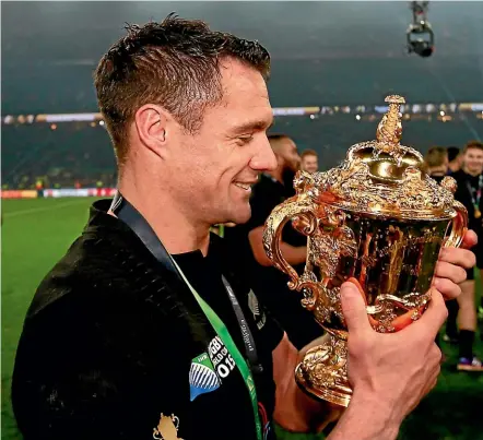  ?? GETTY IMAGES. ?? Dan Carter cradles the Webb Ellis Cup after victory in the 2015 World Cup. Graham Henry says Carter will a logical choice to fill the void left by the injured Damian McKenzie in this year’s squad.