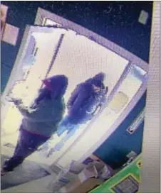  ??  ?? Surveillen­ce footage shows suspects being sought by police in connection with an armed holdup at the Wine and Spirits store Tuesday morning in Media.