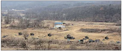  ?? AP/AHN YOUNG-JOON ?? South Korean armored vehicles maneuver Thursday near the North Korean border. Large-scale exercises with U.S. forces planned for early this year are being postponed “in the spirit of the Olympic Games” set to begin Feb. 9 in South Korea, a Pentagon...