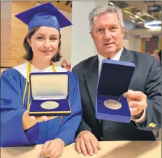  ?? LAWRENCE POWELL ?? Elyse Whitman received both the Queen Elizabeth II Medal and the Governor General Medal from Bridgetown Regional Community School principal Bill Reid June 28 during the school’s first-ever graduation ceremony.