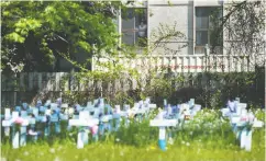  ?? Nathan Denett e / The Cana dian Press Files ?? Crosses marking pandemic deaths are seen at Camilla Care Community Centre in Mississaug­a, Ont., in May.