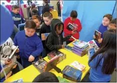  ?? PHOTO VINCENT OSUNA ?? Students from Mr. Rodriguez’s fourth grade class choose a book from an assortment of books set out during National Read Across America Day on Monday at Washington Elementary School in El Centro.