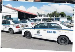  ??  ?? RIGHT: Several police vehicles assigned to the Motorised Patrol were left parked at the Elletson Road Police Station in Kingston, yesterday.