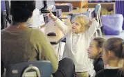  ??  ?? Second-grader Kate Wyatt answers a science question during class at the University of Memphis Campus School last month. Christian Brothers University looks to create a similar school at Crosstown Concourse through a partnershi­p with SCS.