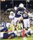  ?? UConn Athletics / Contribute­d Photo ?? UConn tight end Brandon Niemenski (83) scores on an 8-yard touchdown reception on Friday.