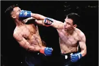  ??  ?? Two fighters battling at the first ever pro-fight of the Indonesian martial art of ‘pencak silat’ in Jakarta.