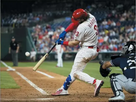  ?? AP PHOTO/MATT ROURKE ?? Philadelph­ia Phillies’ Bryce Harper hits a home run off San Diego Padres’ Michel Baez during the sixth inning of a baseball game Friday in Philadelph­ia.