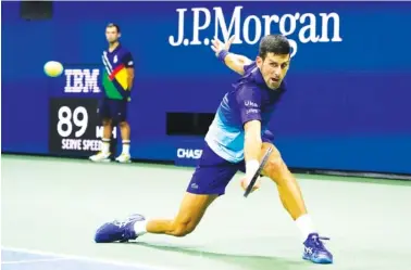 ?? AP PHOTO/JOHN MINCHILLO ?? Novak Djokovic returns a shot to Alexander Zverev during their U.S. Open semifinal Friday night in New York.