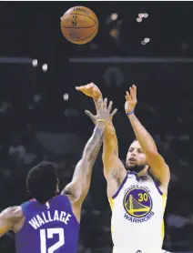  ?? Alex Gallardo / Associated Press ?? Warriors guard Stephen Curry, who had 45 points, shoots over Clippers guard Tyrone Wallace in the third quarter.