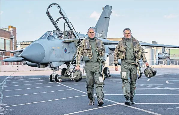  ??  ?? Sqn Ldr Stephen Beardmore and Sqn Ldr Ian Dornan, above, took Tornado ZA463 on its final flight, left, at RAF Marham in Norfolk yesterday