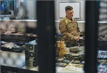  ??  ?? Army Capt. Geoffrey C. Mattoon stands among examples deceased service members’ belongings June 21 at the Joint Personal Effects Depot on Dover Air Force Base, Del. The depot is where the personal effects of deceased service members are processed as part of the dignified transfer.