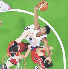  ??  ?? Angel McCoughtry of the US grabs the ball from Ramu Tokashiki and Rui Machida (right) of Japan during the women’s basketball quarterfin­al. — Reuters photo