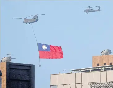  ?? REUTERS ?? A Taiwan flag is flown across the sky during a national day rehearsal in Taipei, Taiwan, yesterday.