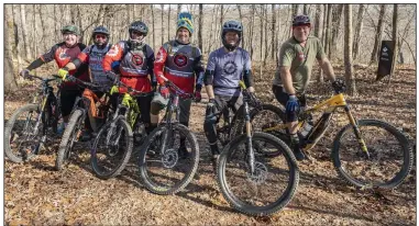  ?? (NWA Democrat-Gazette/Spencer Tirey) ?? The Team Low-T riders (from right) Rusty Cramer, Randy Johnson, Dave Neal, Chuck Young, Tom Miller and Stephen Byrne enjoy a warm December day on Coler Preserve in Bentonvill­e. The group — whose ages range from 50 to 61 — rode the trails on e-bikes, which work by automatica­lly switching on a motor when the bike is pedaled.