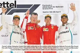  ?? AFPPIX ?? Ferrari’s driver Sebastian Vettel (2nd right) celebrates on the podium after winning the Bahrain Formula One Grand Prix with Ferrari mechanic Pietro Timpini (2nd left), Mercedes’ Valtteri Bottas (left) who came second and Mercedes’ Lewis Hamilton (right) who came third at the Sakhir circuit in Manama yesterday. –