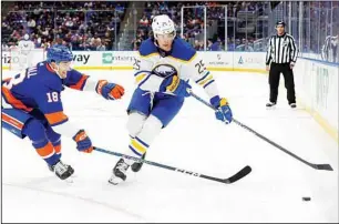  ?? ?? New York Islanders’ Pierre Engvall (18) and Buffalo Sabres’ Owen Power (25) chase the puck during the first period of an NHL hockey game in Elmont, N.Y. (AP)