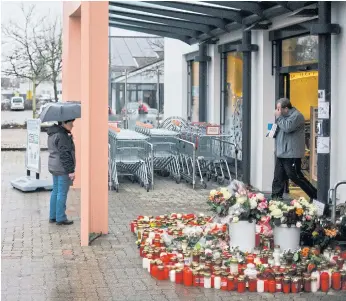  ??  ?? IN MEMORY: Flowers and candles laid out at the entrance of the drugstore where a teenage girl, Mia V, was stabbed to death by her ex-boyfriend, Abdul D, on Dec 27 in the small town of Kandel, Germany.