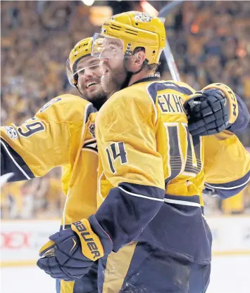  ?? AP ?? The Predators’ Mattias Ekholm, No.14, celebrates his goal against the Penguins with teammate Roman Josi.