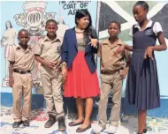  ?? PHOTOS BY AMITABH SHARMA ?? Elanor Nelson (in th middle), Peace Corps volunteer at the Newstead Primary School, St Mary, with some students who helped her create a pavement from soda bottle caps.