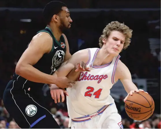  ?? | NAM Y. HUH/ AP ?? Rookie forward Lauri Markkanen, playing in his first game in 12 days after battling back spasms, drives around Bucks forward Jabari Parker in the Bulls’ loss Friday.