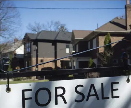  ?? GRAEME ROY, THE CANADIAN PRESS ?? Home sales are down 14.1 per cent from the record level set in March, the latest evidence that a cool-down in the housing sector is taking hold.