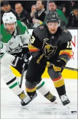  ??  ?? Golden Knights forward Brendan Leipsic (13) chases after a loose puck with Stars center Jason Spezza (90) in hot pursuit.