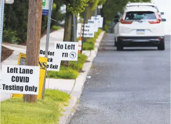  ?? RICK KINTZEL/MORNING CALL FILE PHOTO ?? Signs instruct motorists on which lane to proceed in for testing at Easton Hospital in Wilson Borough.