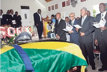  ?? NORMAN GRINDLEY/CHIEF PHOTO EDITOR ?? Former Commission­ers of Police (from left) Dr Carl Williams, Lucius Thomas, and Owen Ellington, along with former Assistant Commission­er of Police Aurther ‘Stitch’ Martin (right), stand in front of the flag-draped coffin of Winchroy Budhoo, who was an...