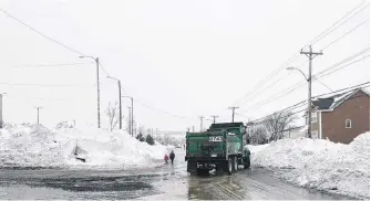  ?? ANDREW WATERMAN/THE TELEGRAM ?? City plows coming and going were a constant on Blackler Avenue on Monday, as they continued to tackle the snow from Friday’s storm.