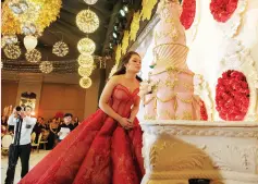  ??  ?? THE debutante with her cake